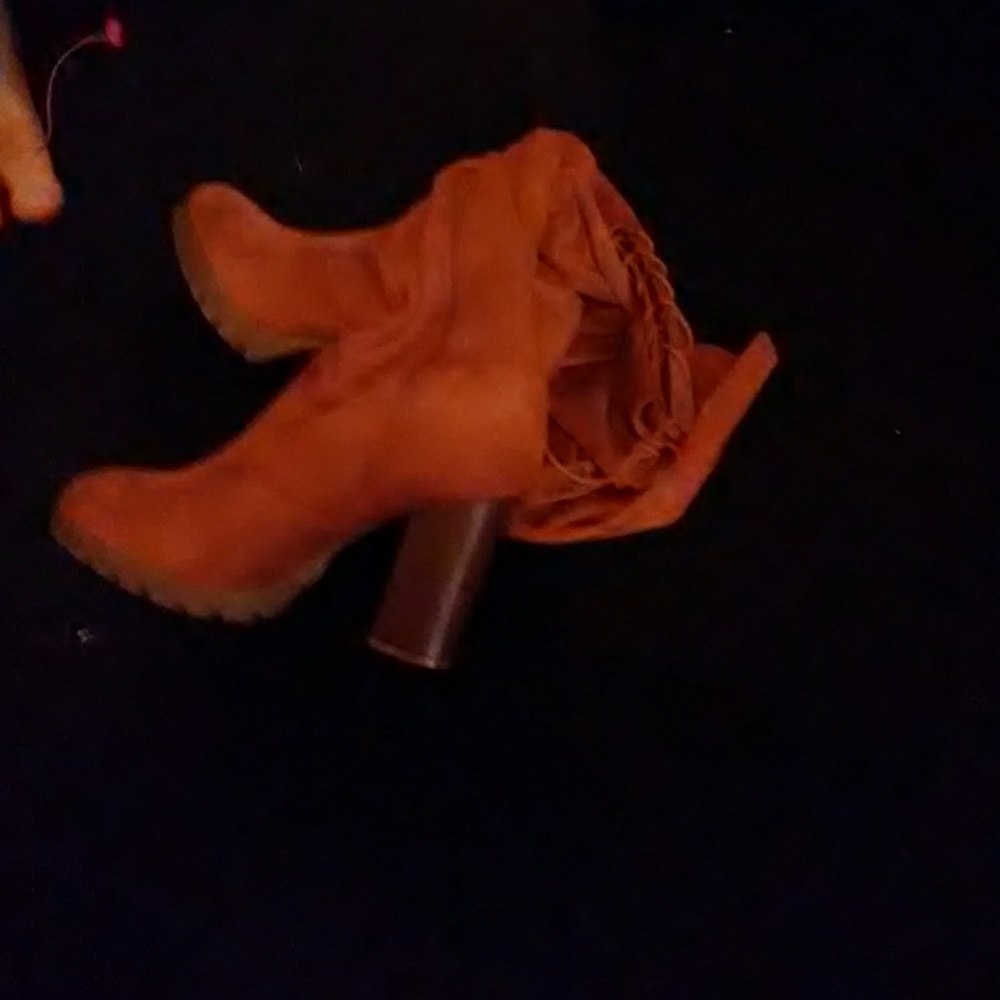 Tall brown boots lace up above knee with heel